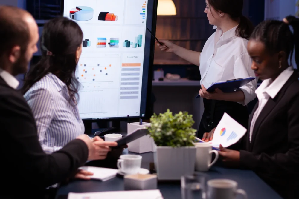 diverse-multi-ethnic-business-teamwork-overworking-office-meeting-room-analyzing-financial-graphs