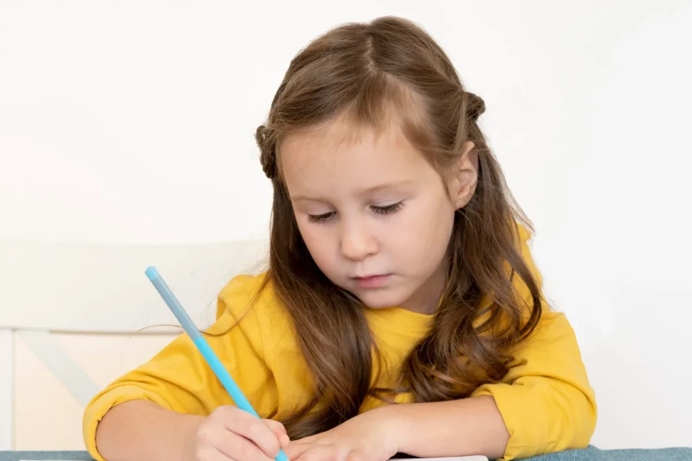 front-view-little-girl-doing-her-homework